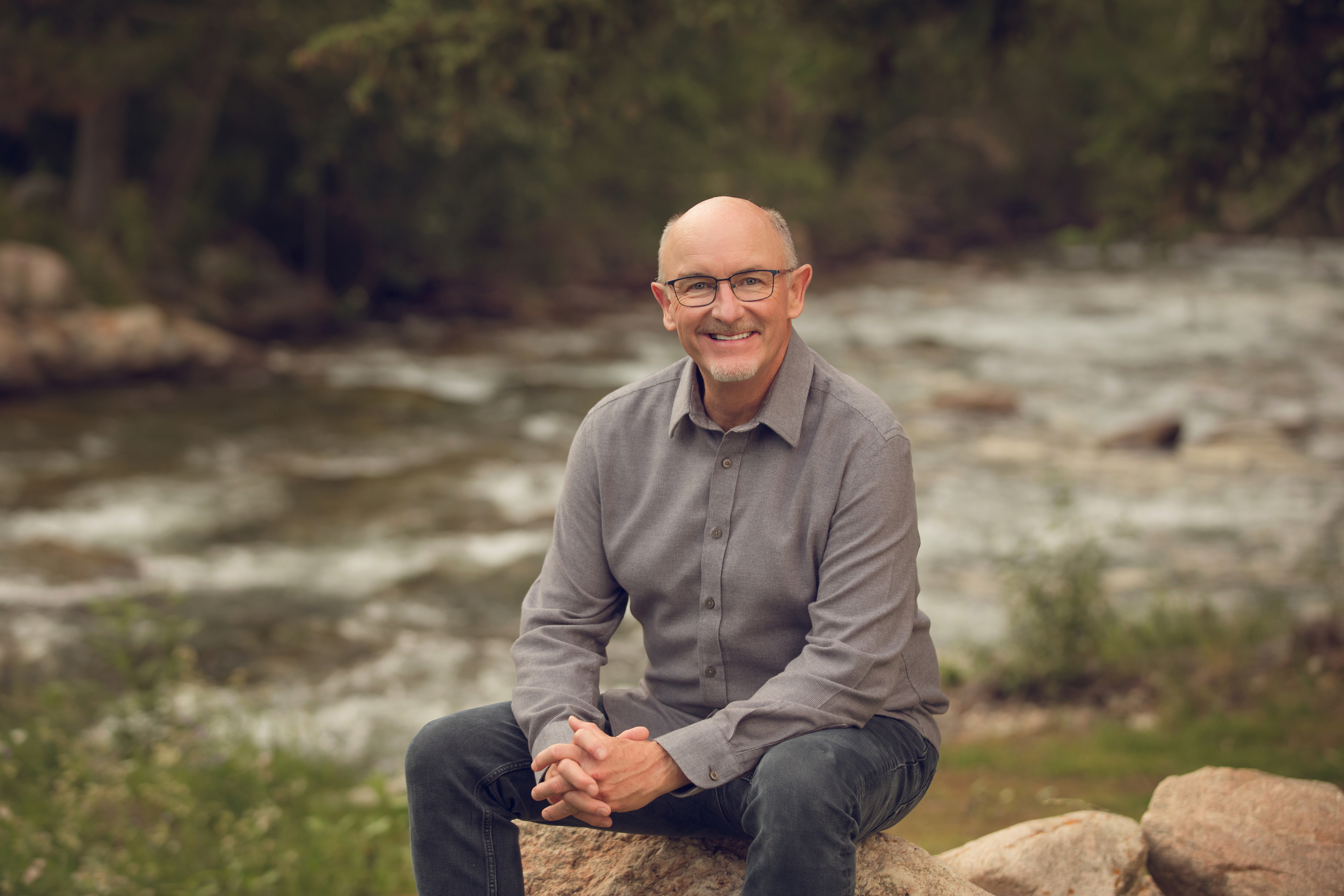 Daniel sitting on a rock